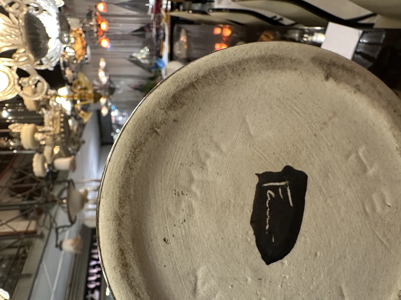 Antique ceramic plate with subtle decoration and signature