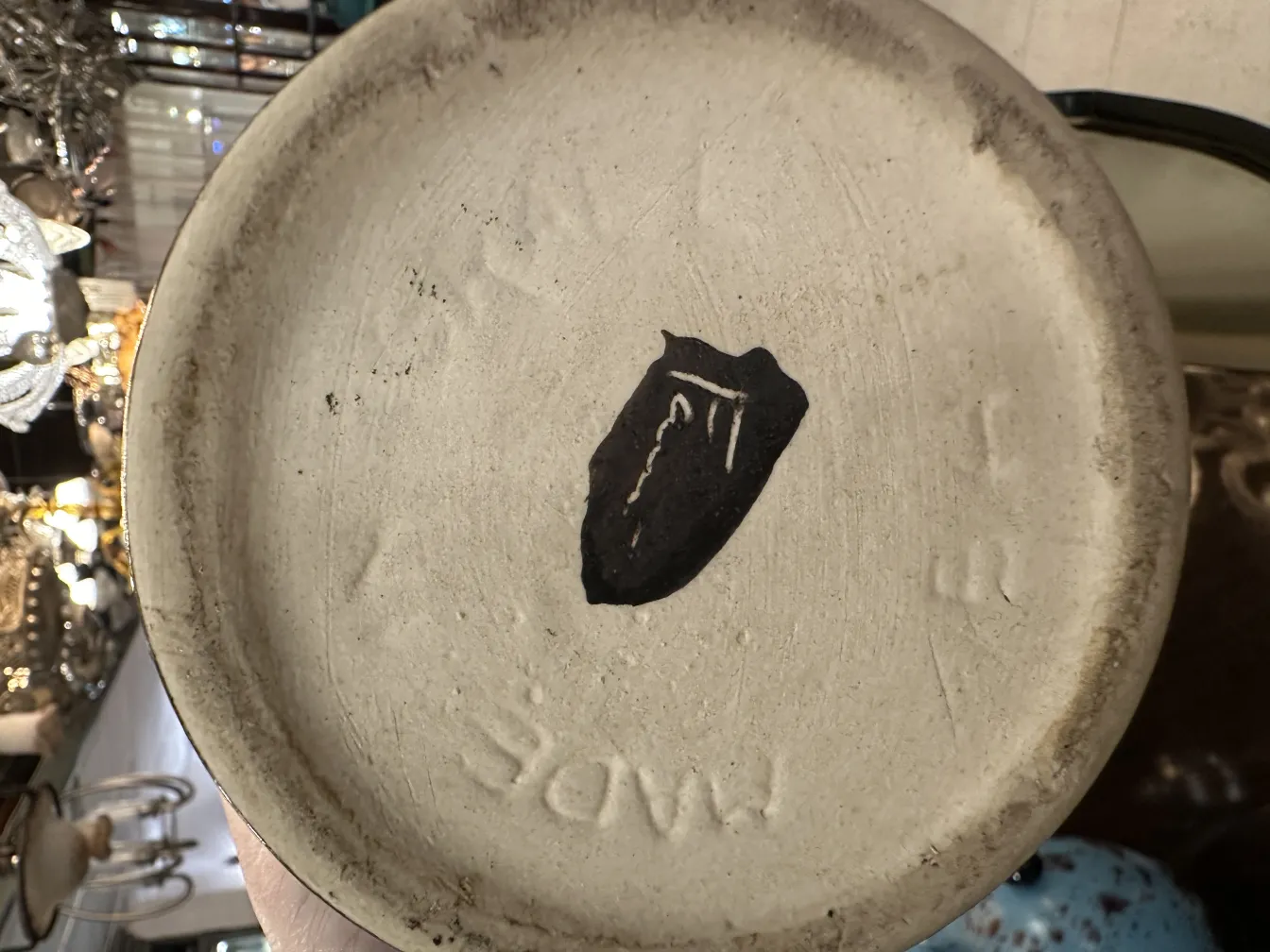 Antique ceramic plate with visible decorative details in a vintage setting.