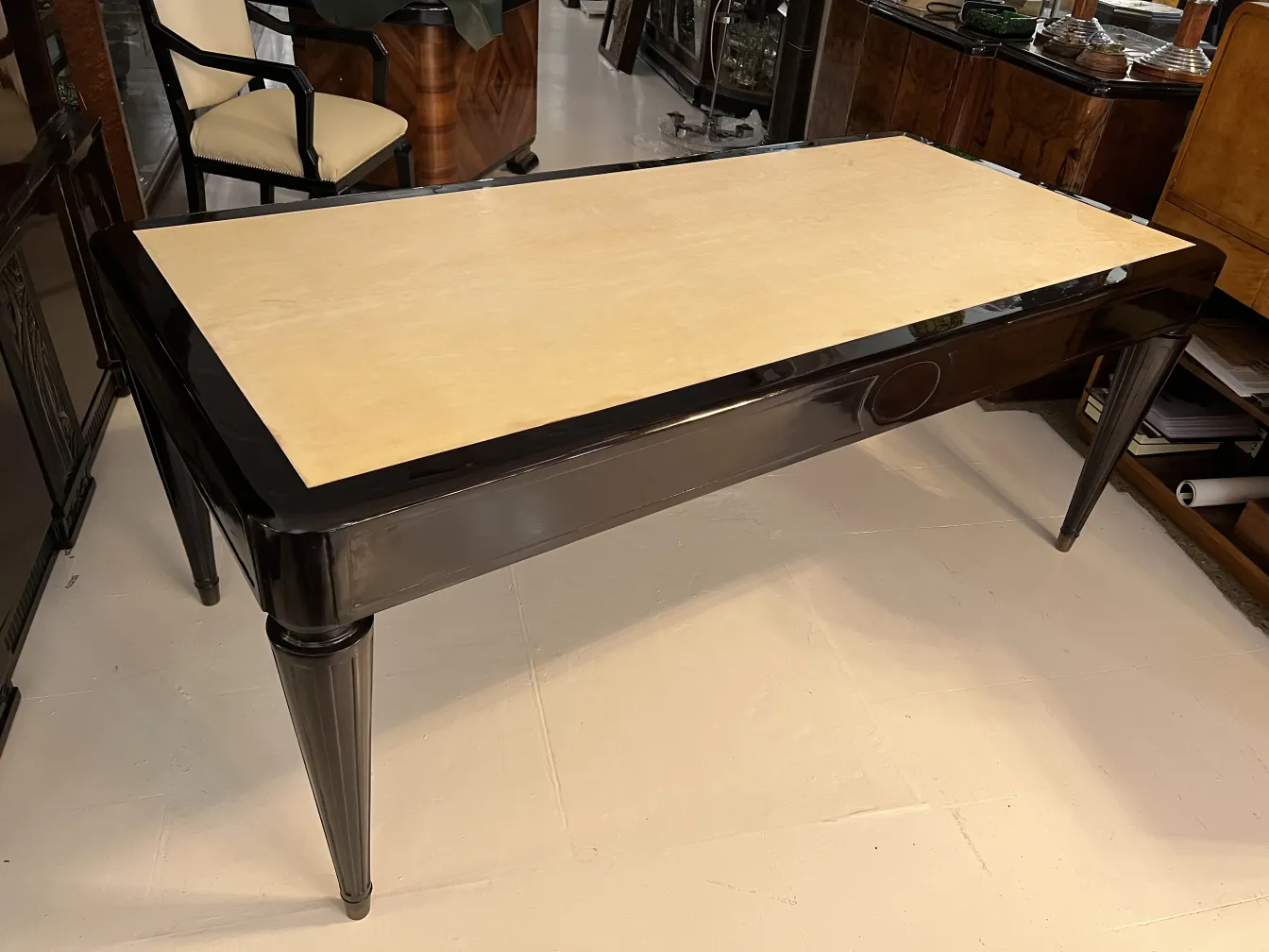 Antique Nordiska Kompaniet desk with an elegant design and classic legs. Background in a room with other decorative items.