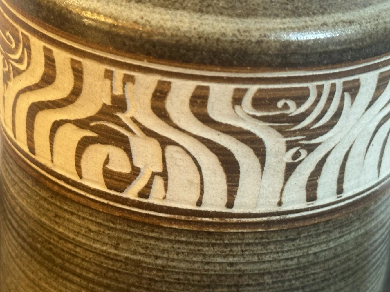 Antique ceramic decoration featuring light and dark patterns.