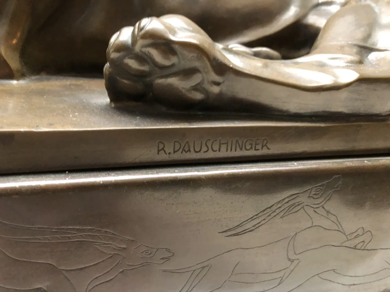 antique sculpture with animal details on the base