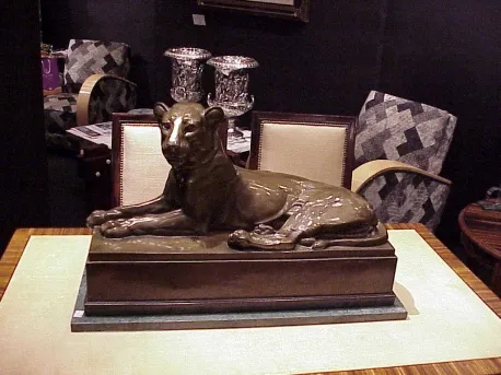 antique sculpture of a lion on an elegant table