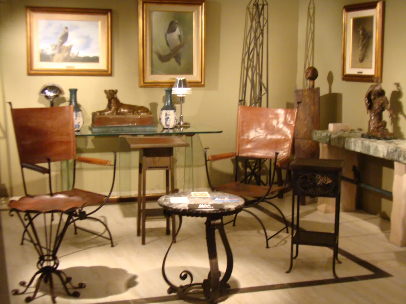 antique sculpture in a setting with chairs and tables