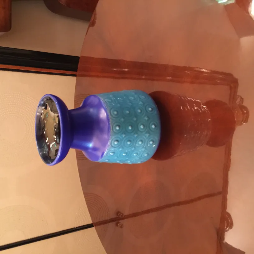 Antique blue ceramic vase with textured design on the bottom.