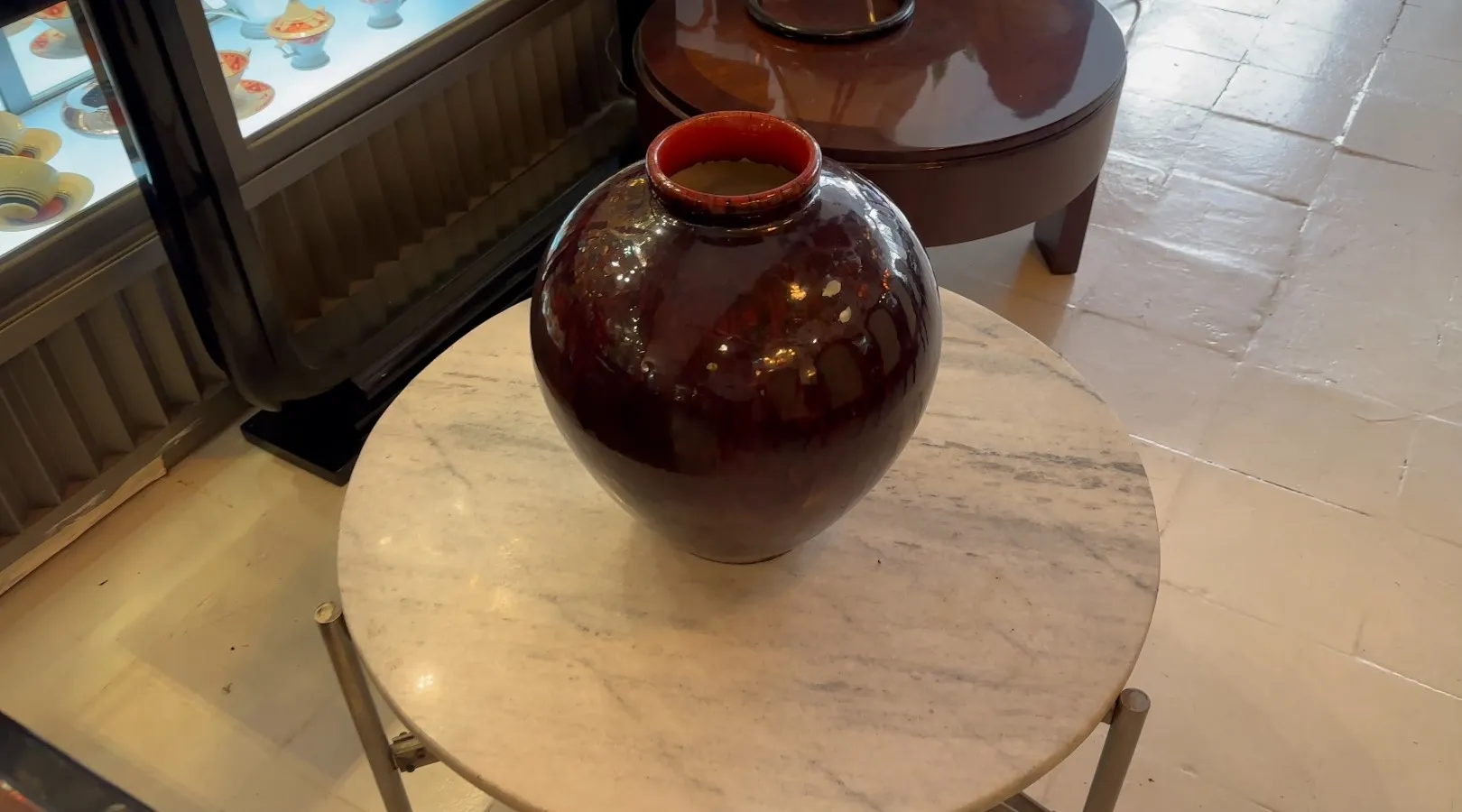 Antique round ceramic vase on marble table