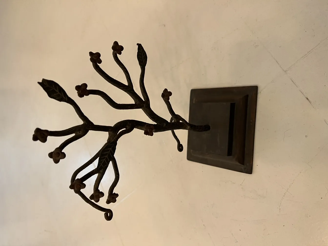 antique sculpture shaped like a tree with leaves and flowers