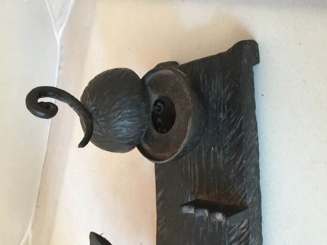 antique sculpture shaped like a head with a decorative hat