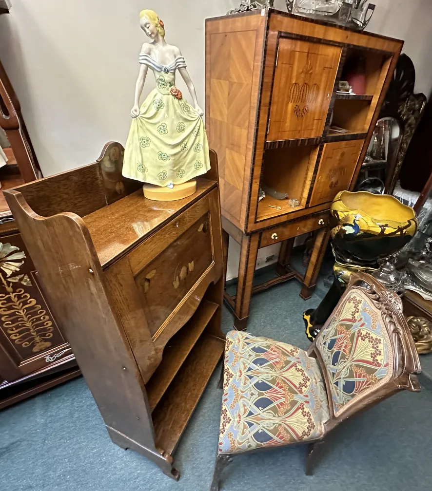 antique desk with decorative figure and colorful chair