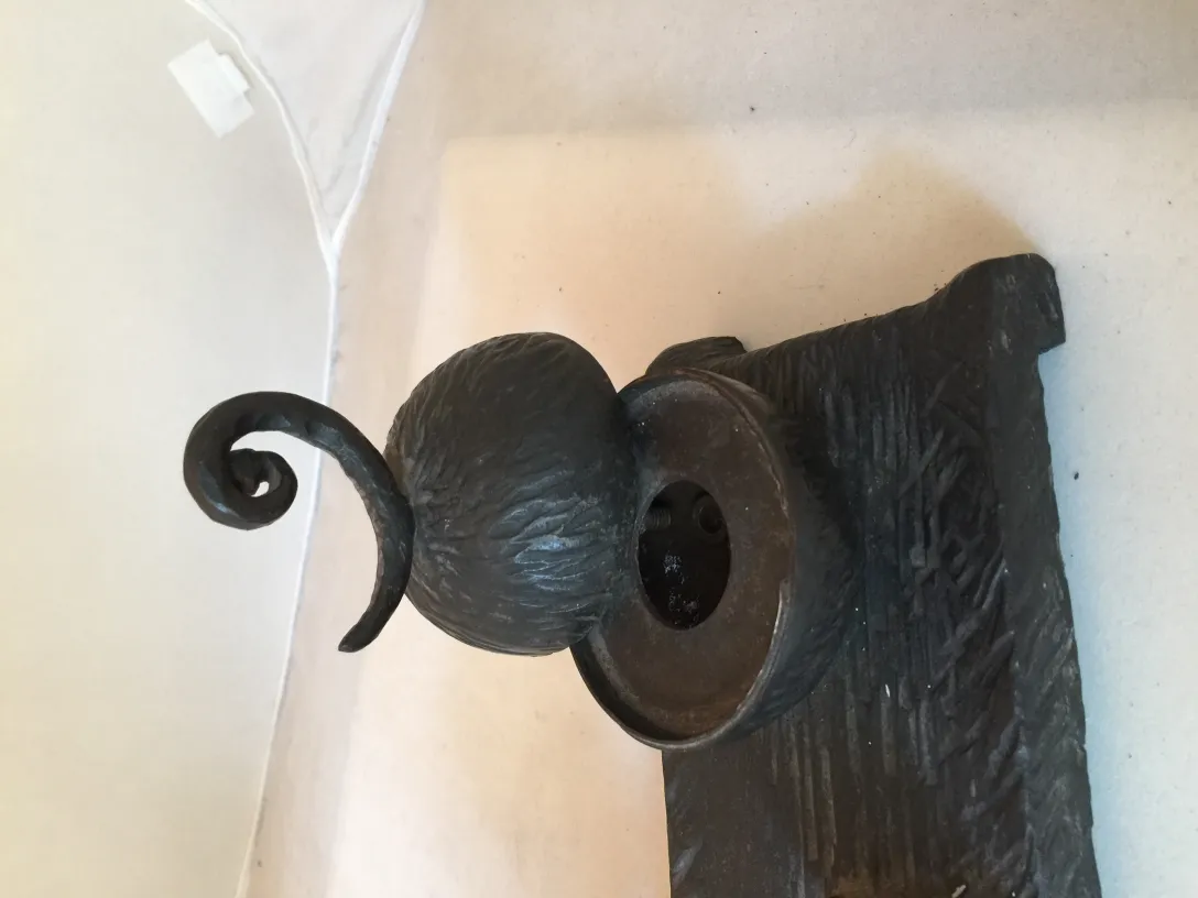 antique sculpture featuring rounded shapes and decorative base on light background