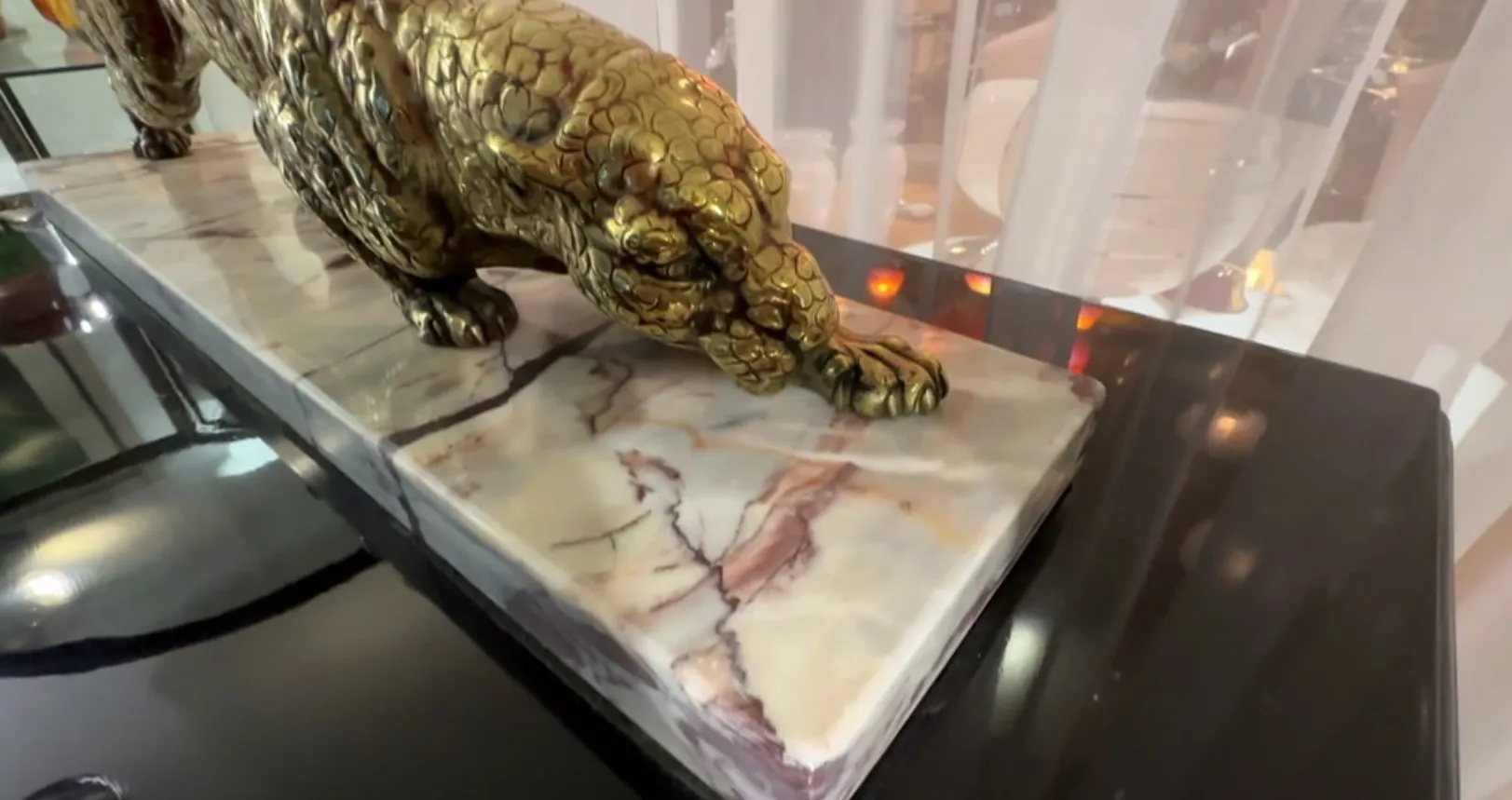 antique animal sculpture on a decorative base with details