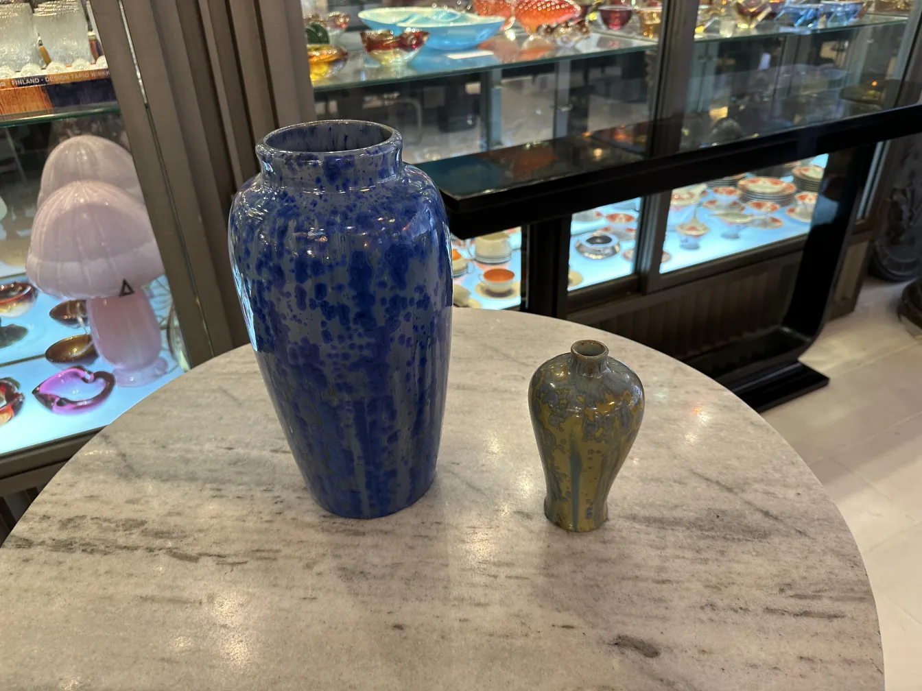 Antique ceramic vases with blue decorations on marble