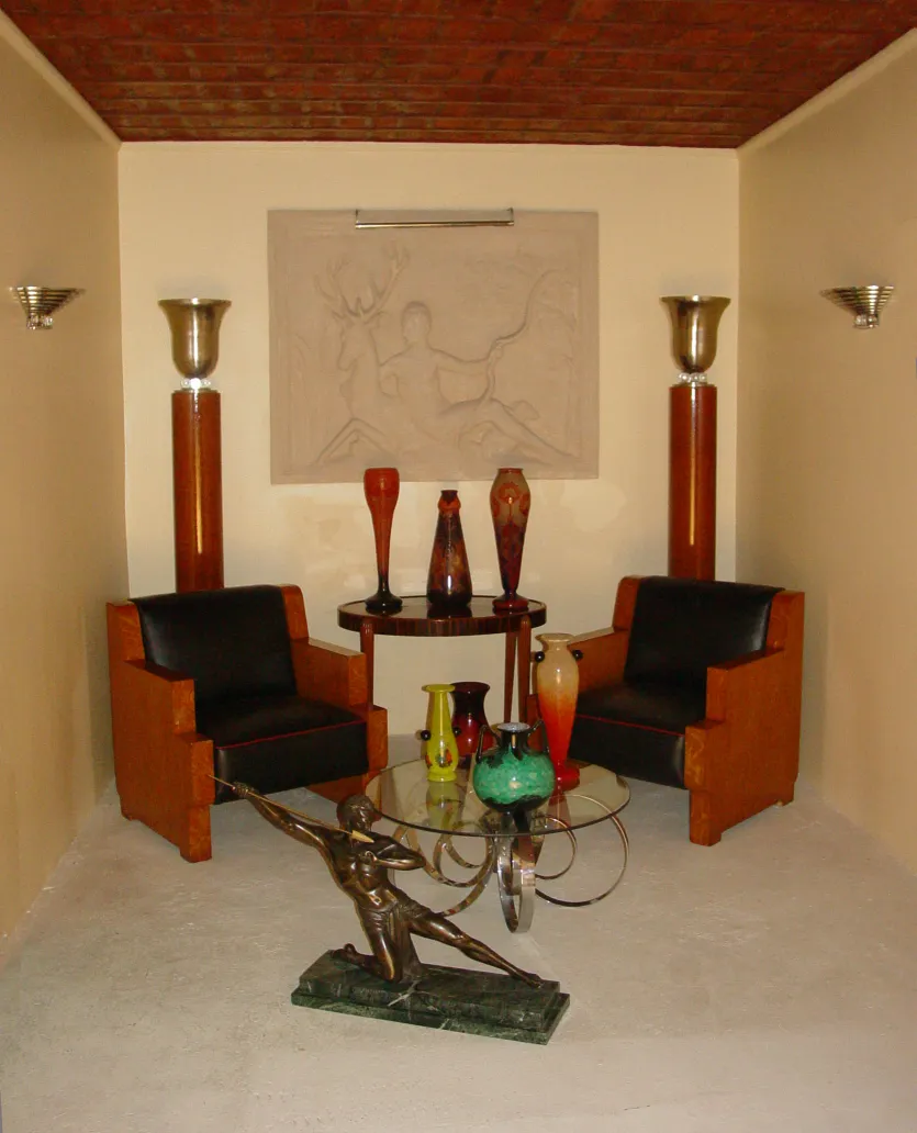 Antique sculpture in the center of a cozy living room setting.