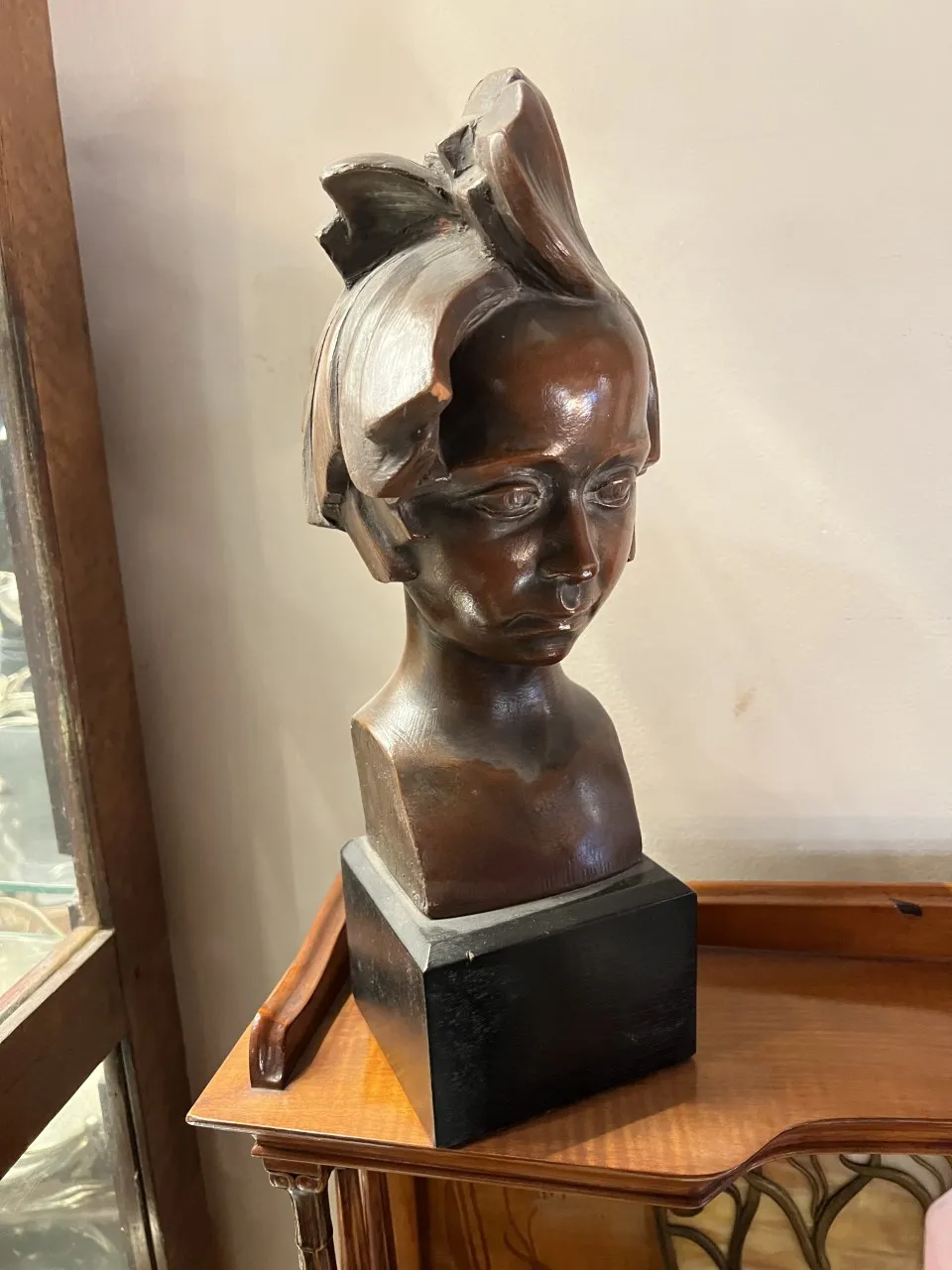 Antique sculpture of a portrait with realistic details, cozy setting.