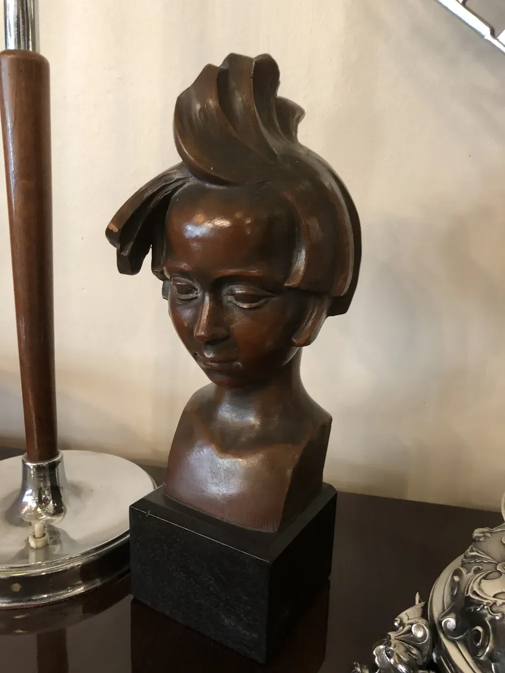 escultura antigua de una cabeza humana con peinado único
