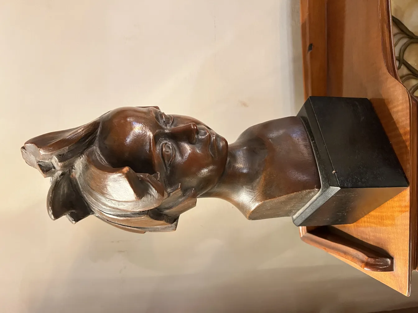 Antique sculpture of a female bust in brown tone