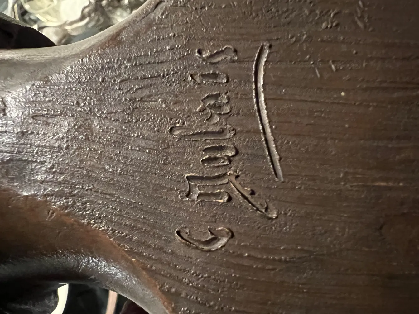 antique decorative sculpture with elegantly carved signature