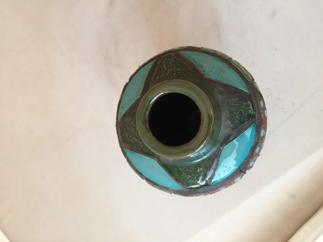 Antique vase decorated with turquoise shades and geometric design