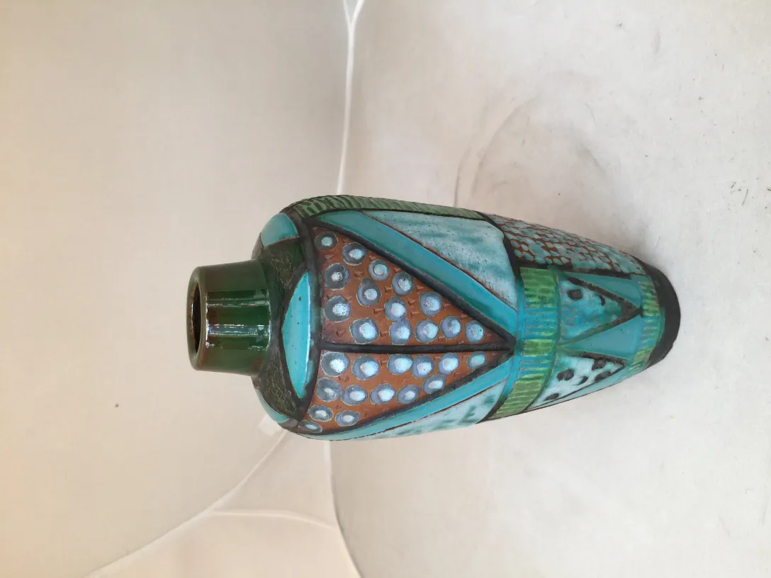 antique ceramic vase decorated in greenish and terracotta tones, geometric shapes