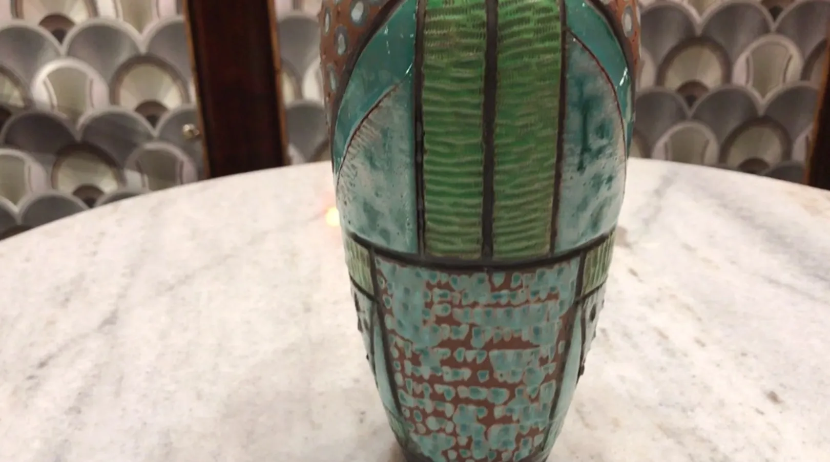 Antique ceramic vase with colorful textured design