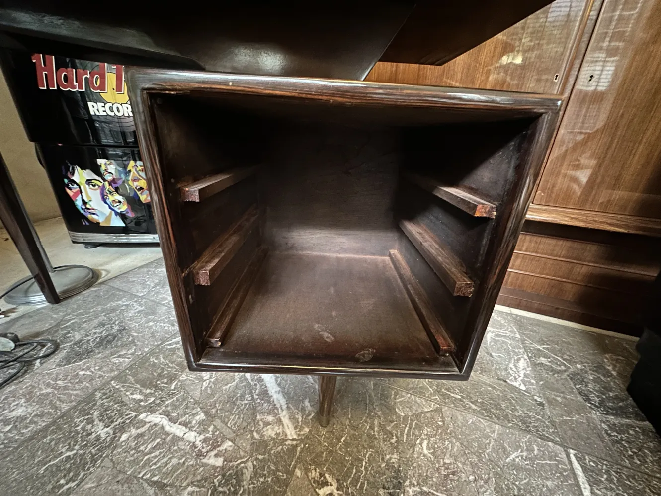 Interior of an antique desk with empty storage space.