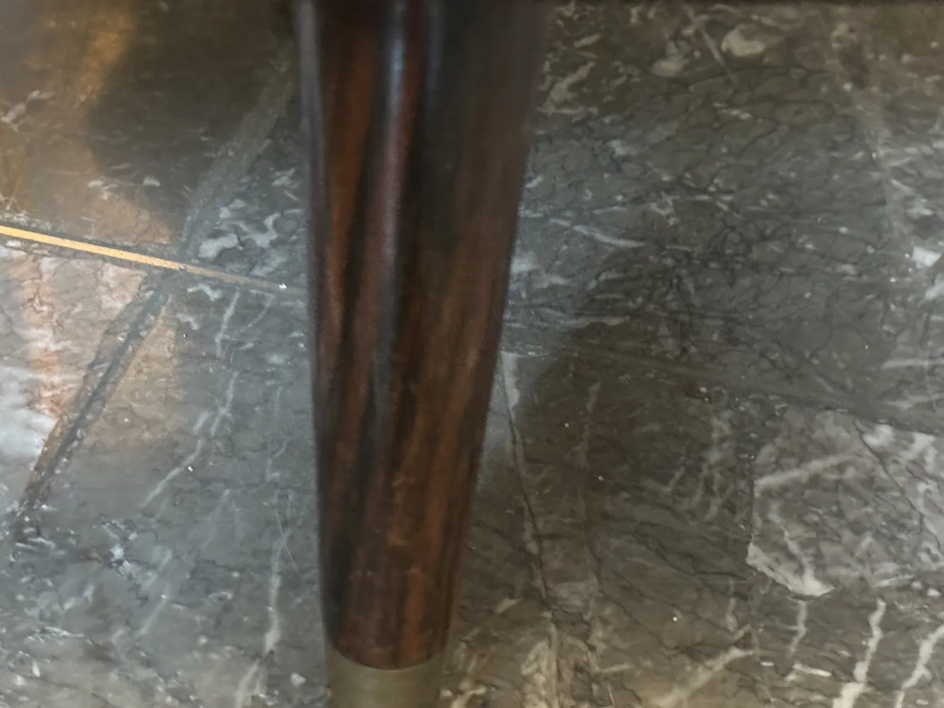 Leg of an antique classic desk with curved detail.