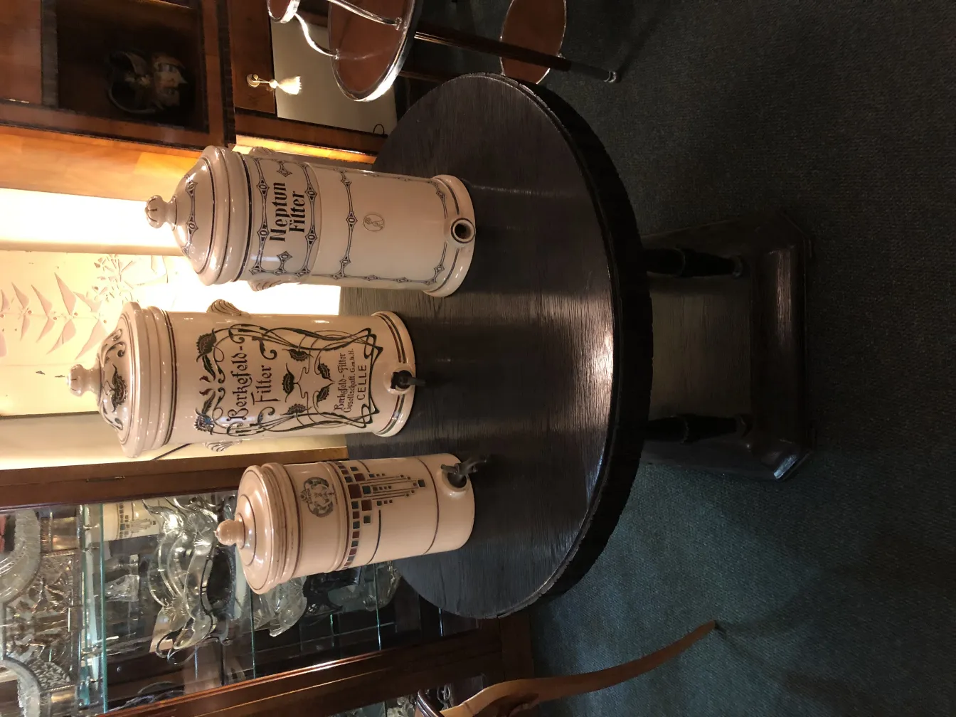 three antique ceramic jars on a table
