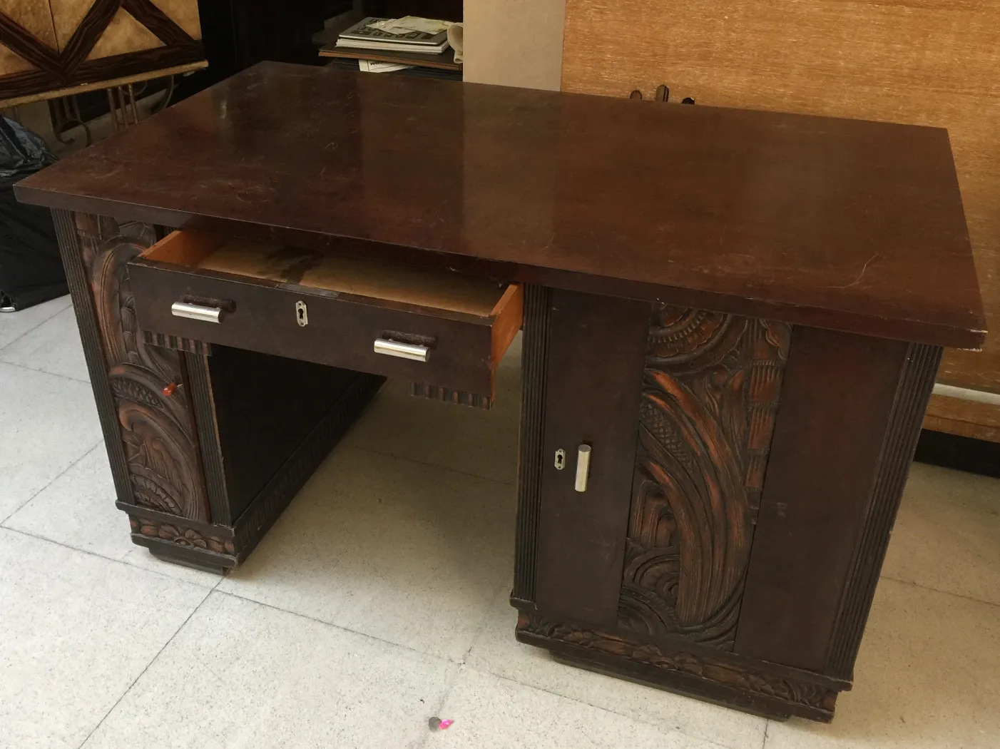 antique desk featuring a drawer and decorative elements