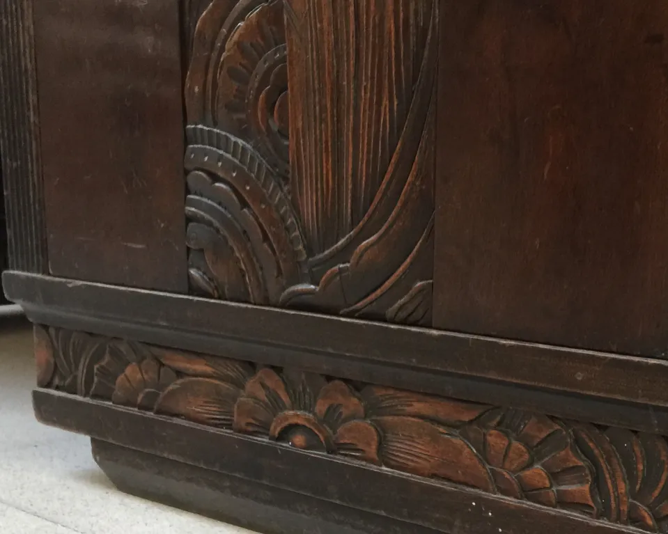 detail of an antique desk with floral carvings