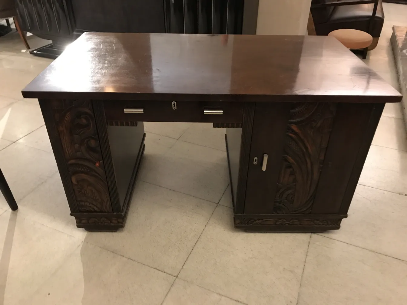 antique desk featuring artistic carvings on the sides