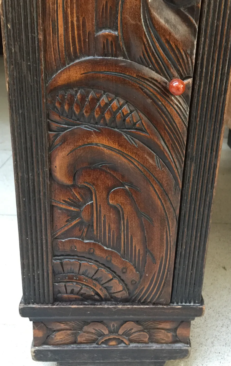 carved details of an antique desk with intricate design
