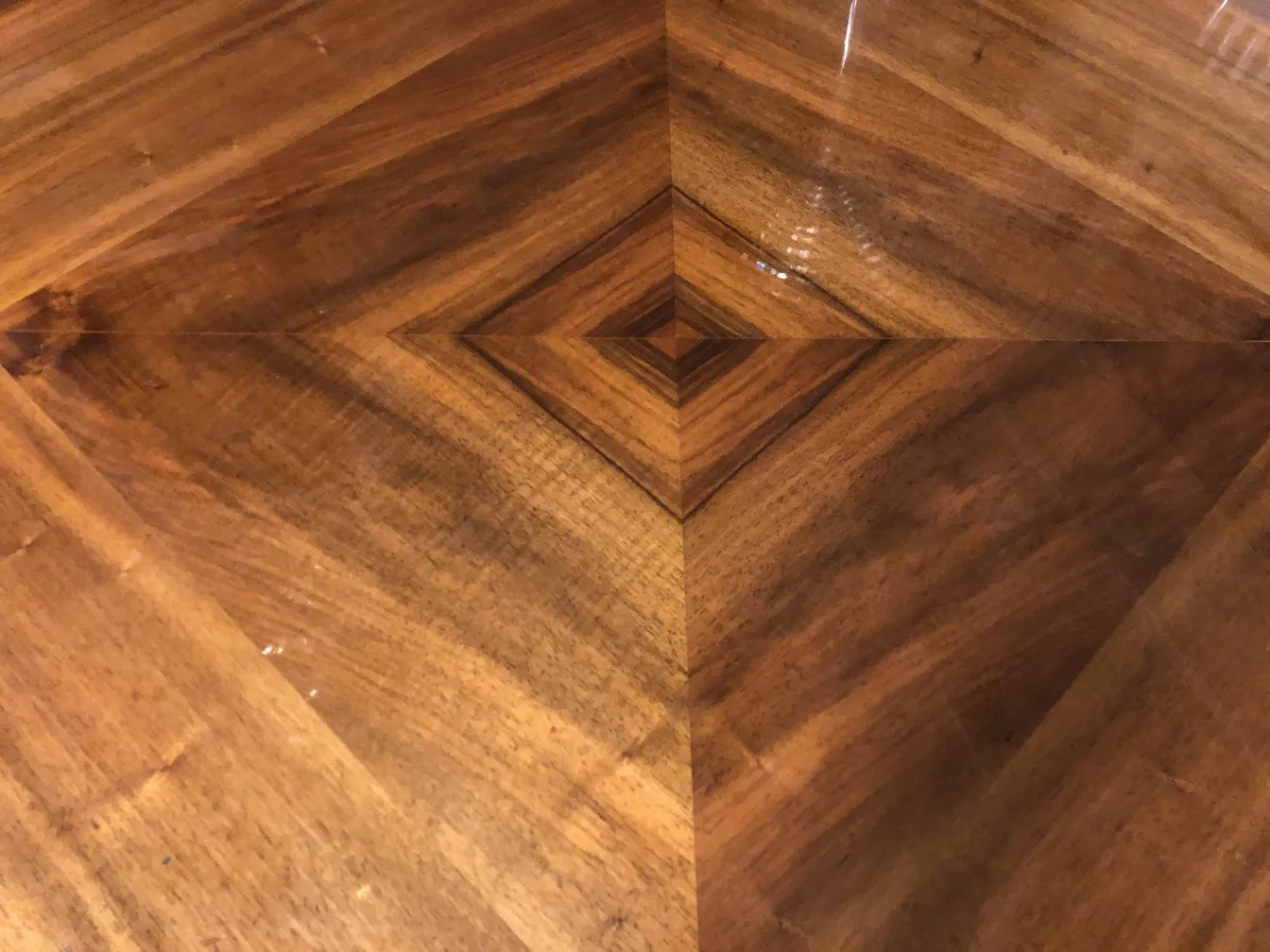 antique desk features a geometric design on its surface