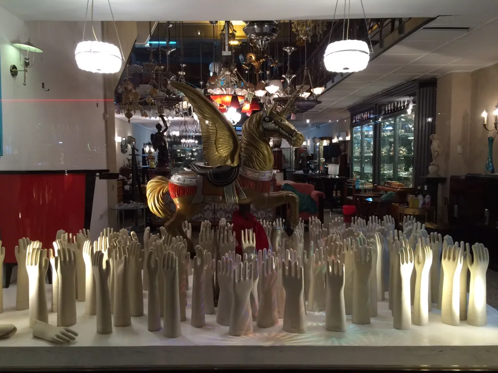 Vitrine mit Antiquitäten und hellen dekorativen Keramiken