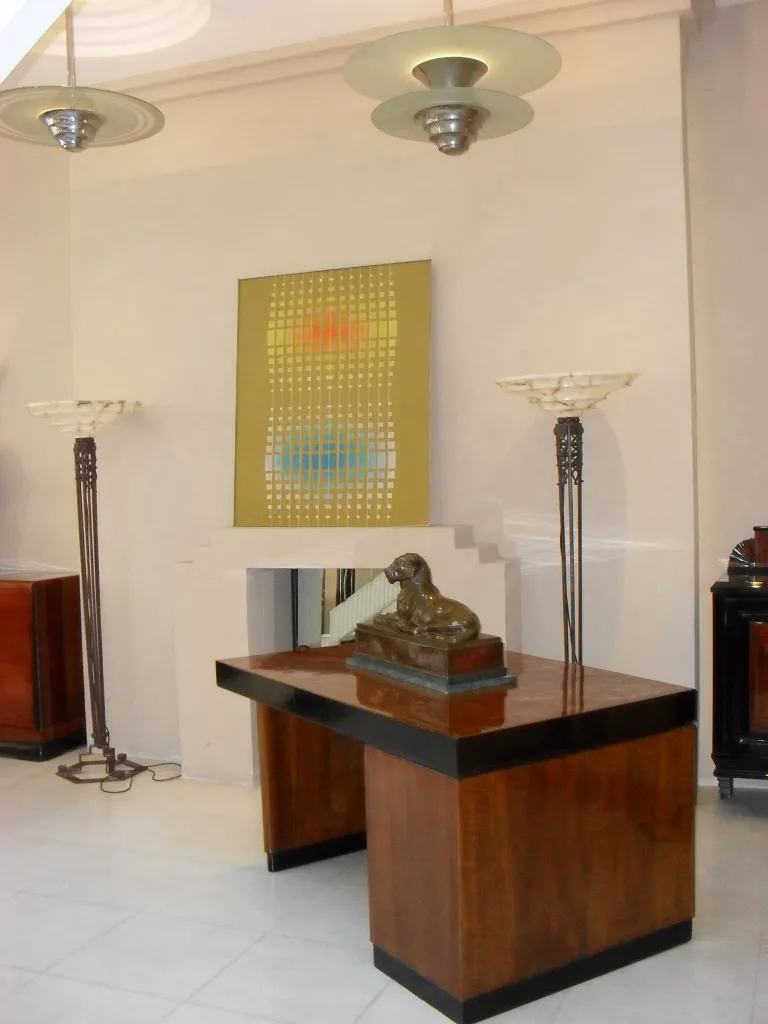 antique wooden desk with lamps and modern art