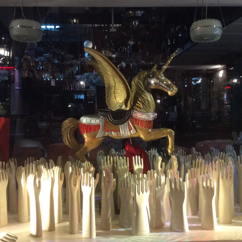 antique ceramic figure with white hands in a decorative setting