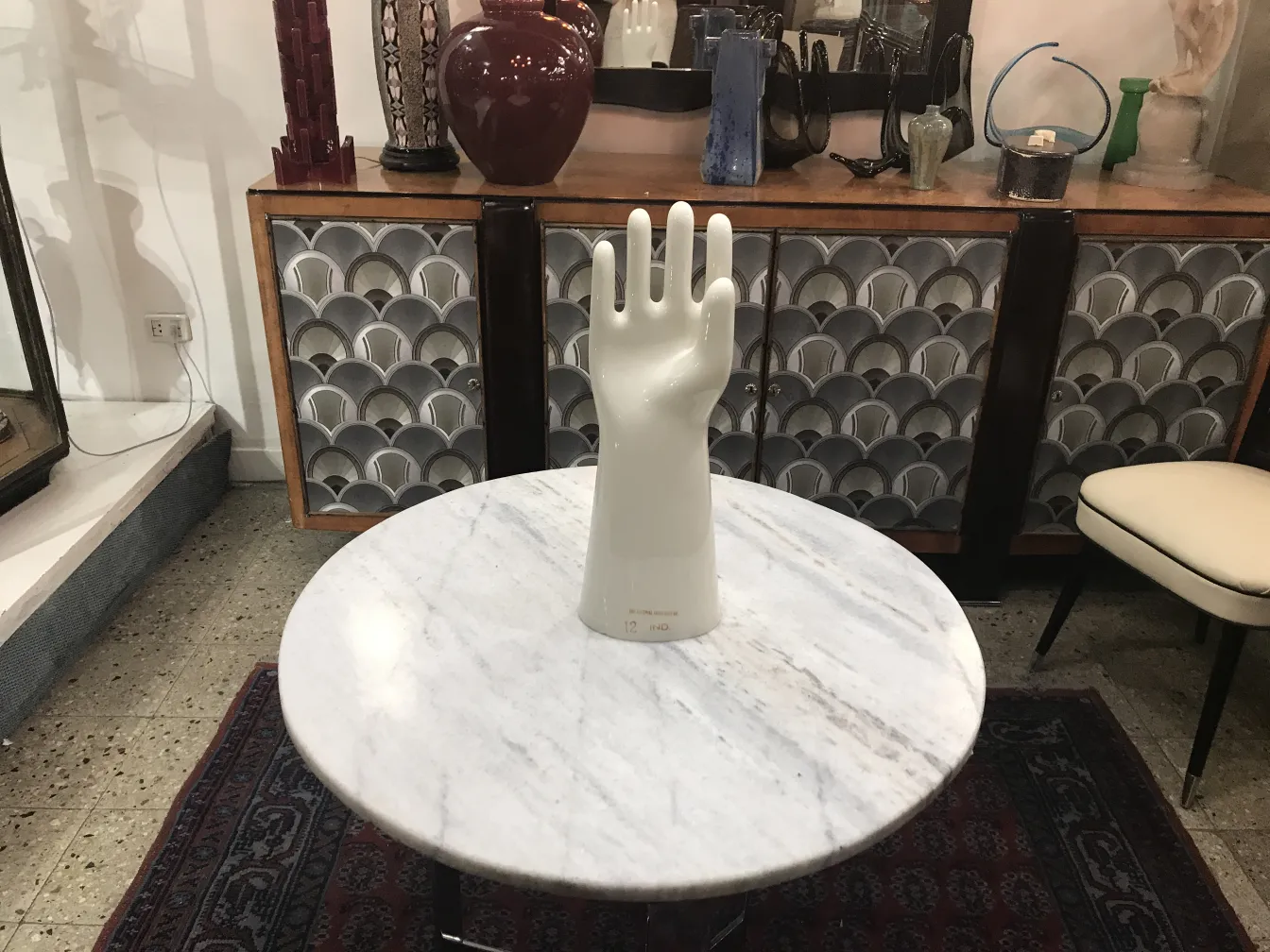 antique ceramic hand sculpture on a tabletop