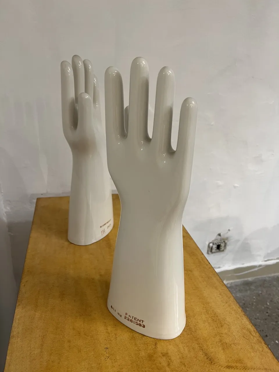 two decorative antique ceramic hands in glossy white