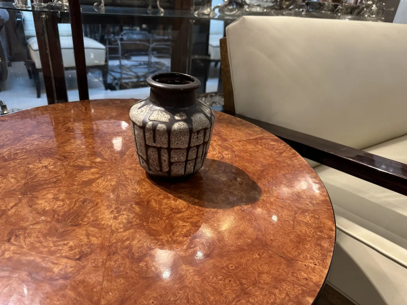 Antique decorative ceramic vase on a wooden table.
