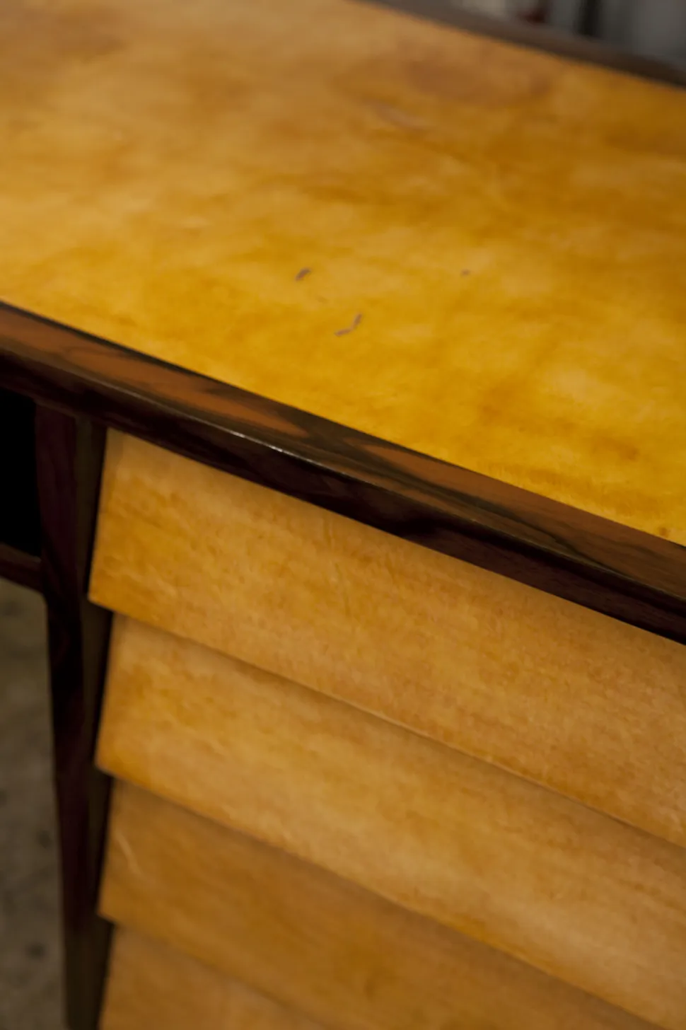 Antique desk with a yellow surface and drawers