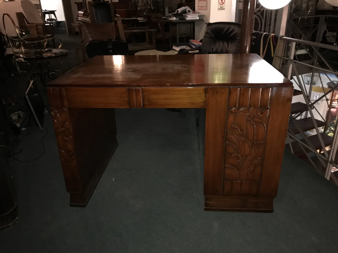 Antique wooden desk with carved details.