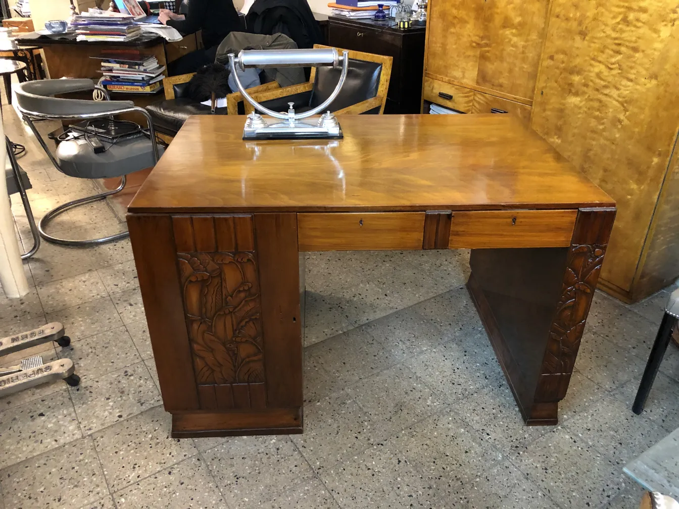Antique desk with carved design and lamp