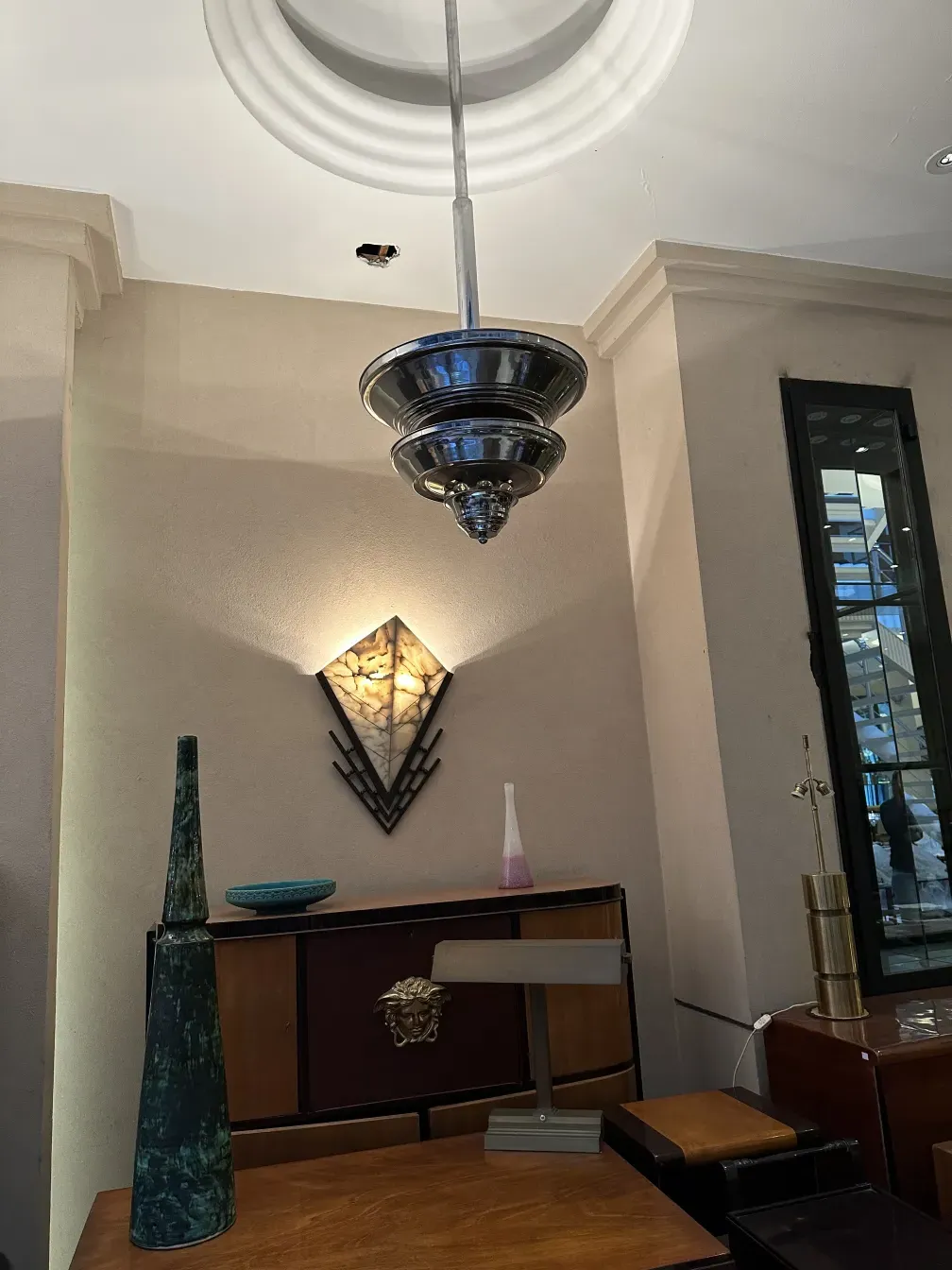 Antique desk with a lamp and modern decoration. Elegant atmosphere.