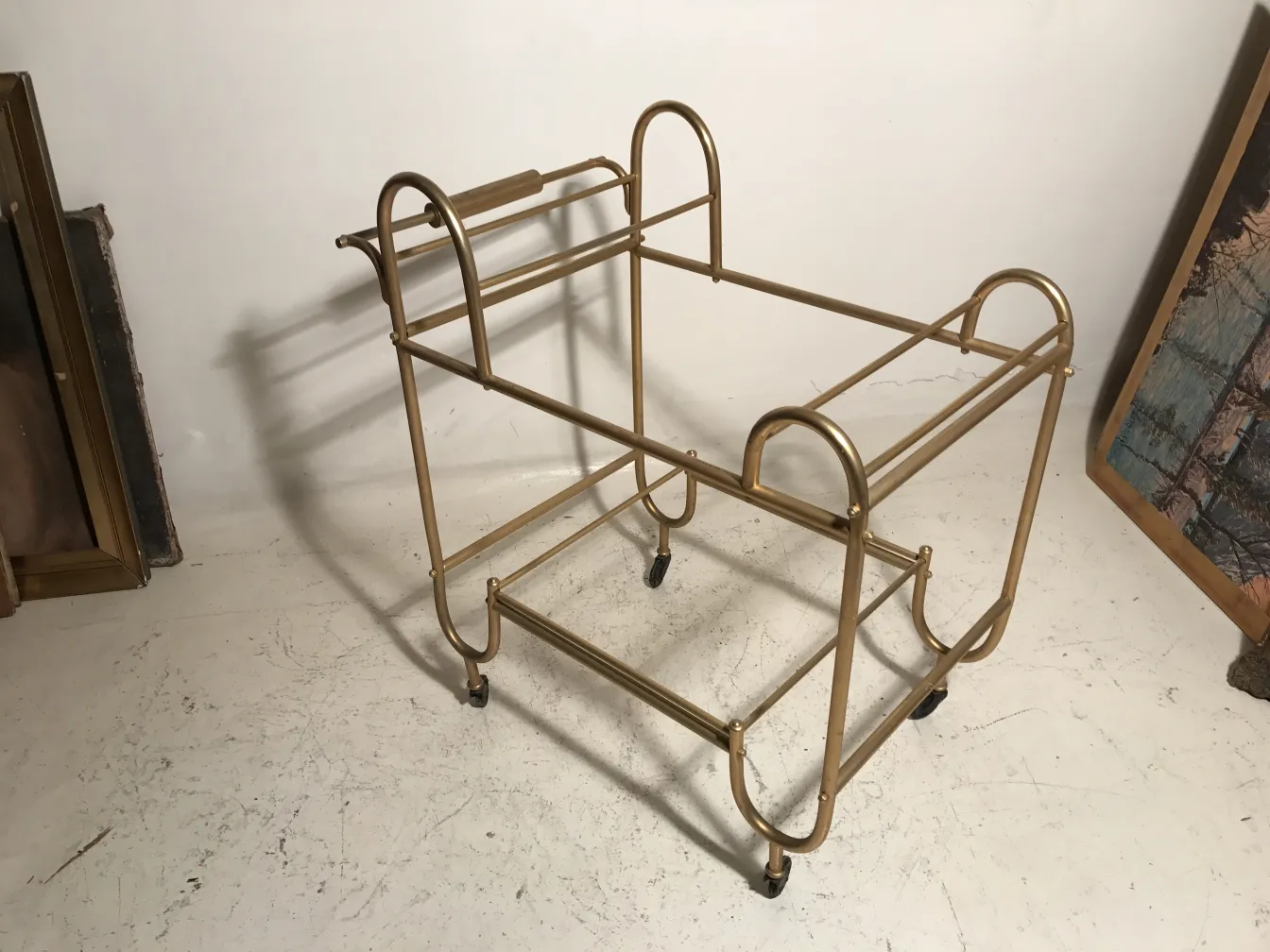 Antique cocktail trolley with elegant design in simple setting.