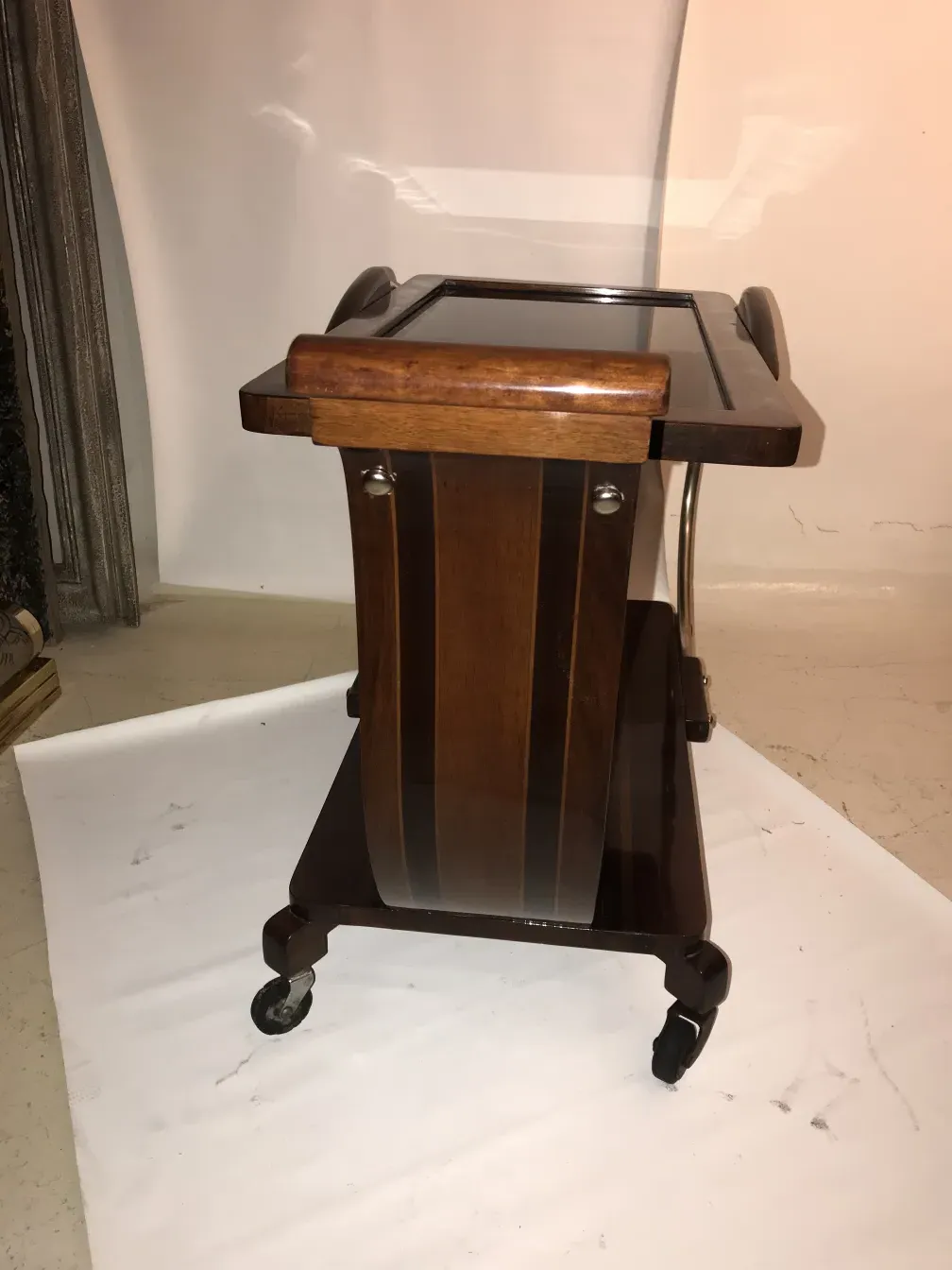 Antique cocktail trolley featuring a stylish design and wheels.