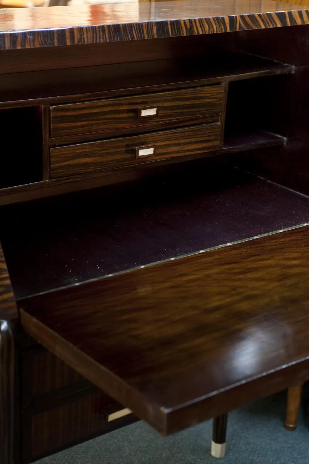 bureau ancien en bois avec deux tiroirs visibles et surface brillante