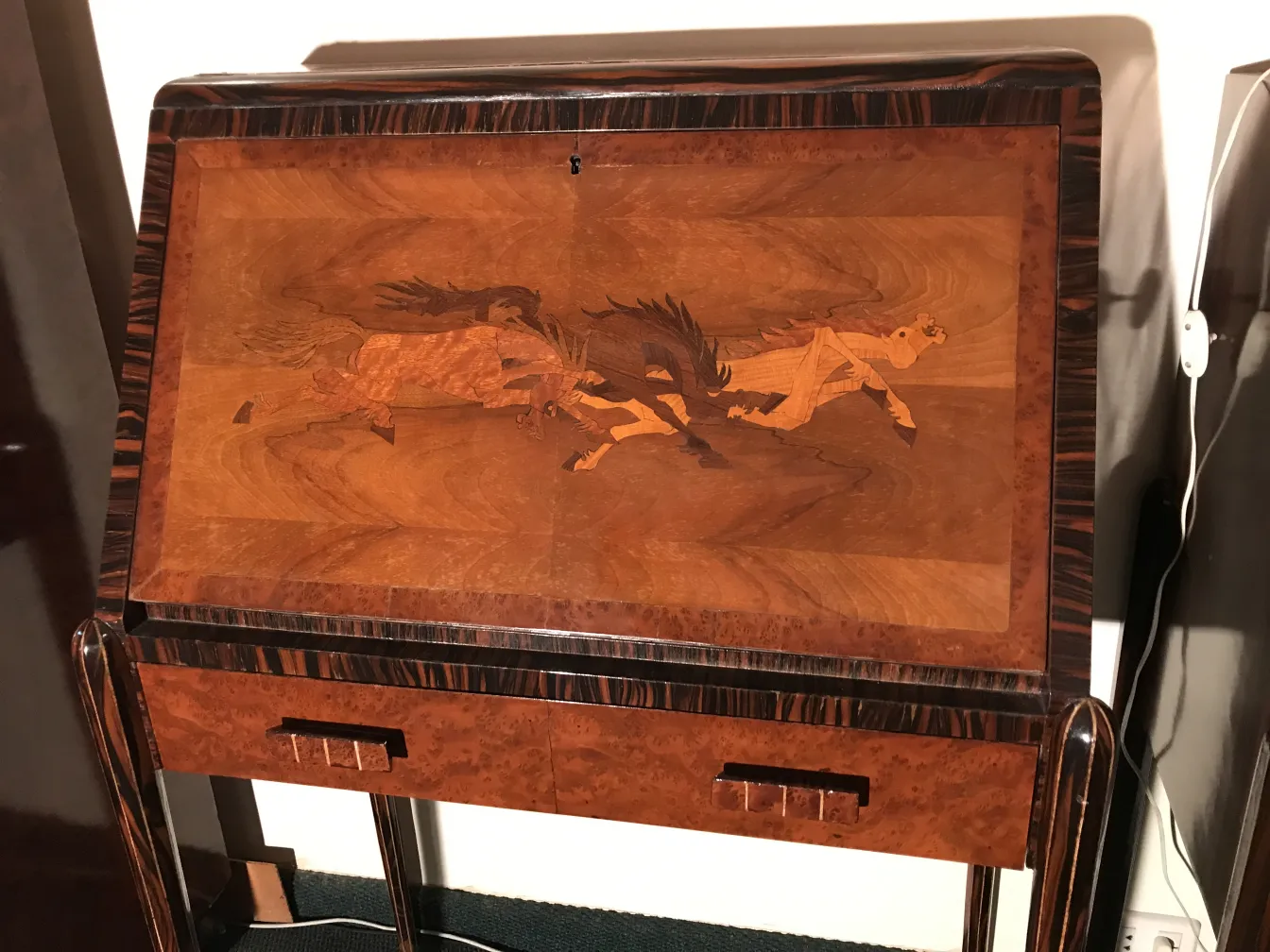antique desk featuring horses on the surface