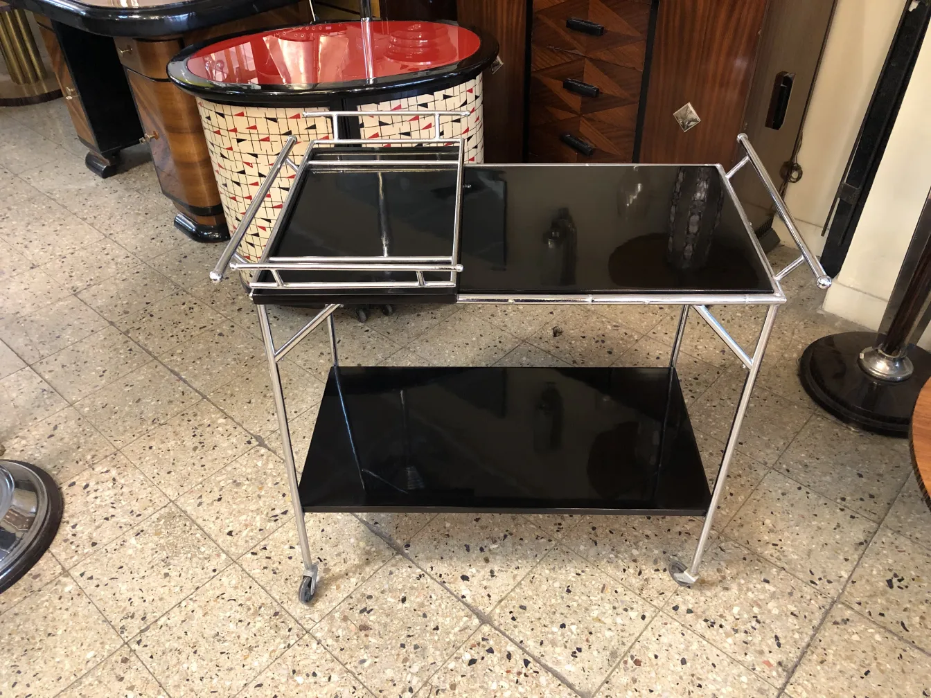 Antique cocktail trolley with black finish and metal frame.