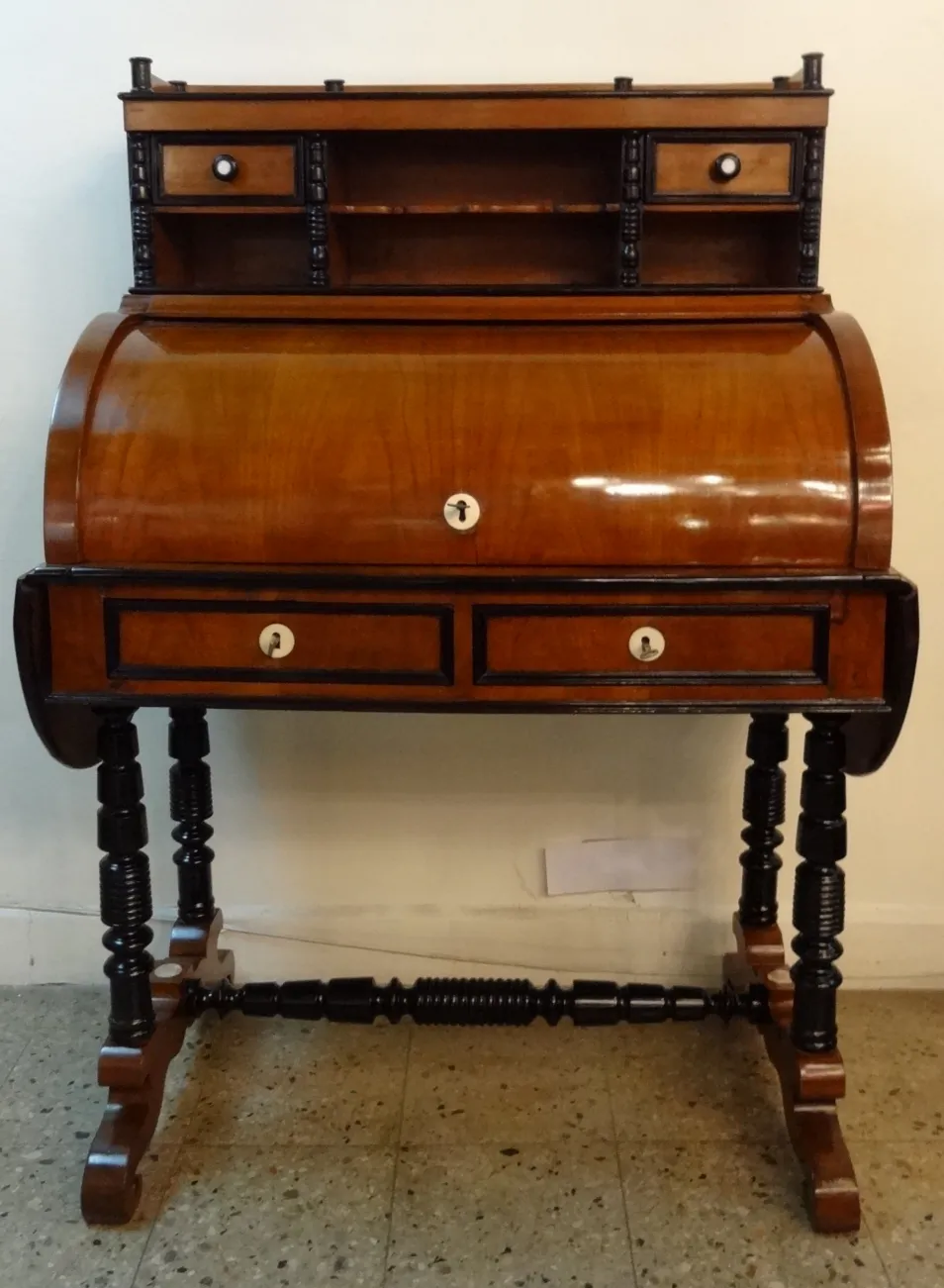 antique wooden desk with shelves and two drawers, neutral background