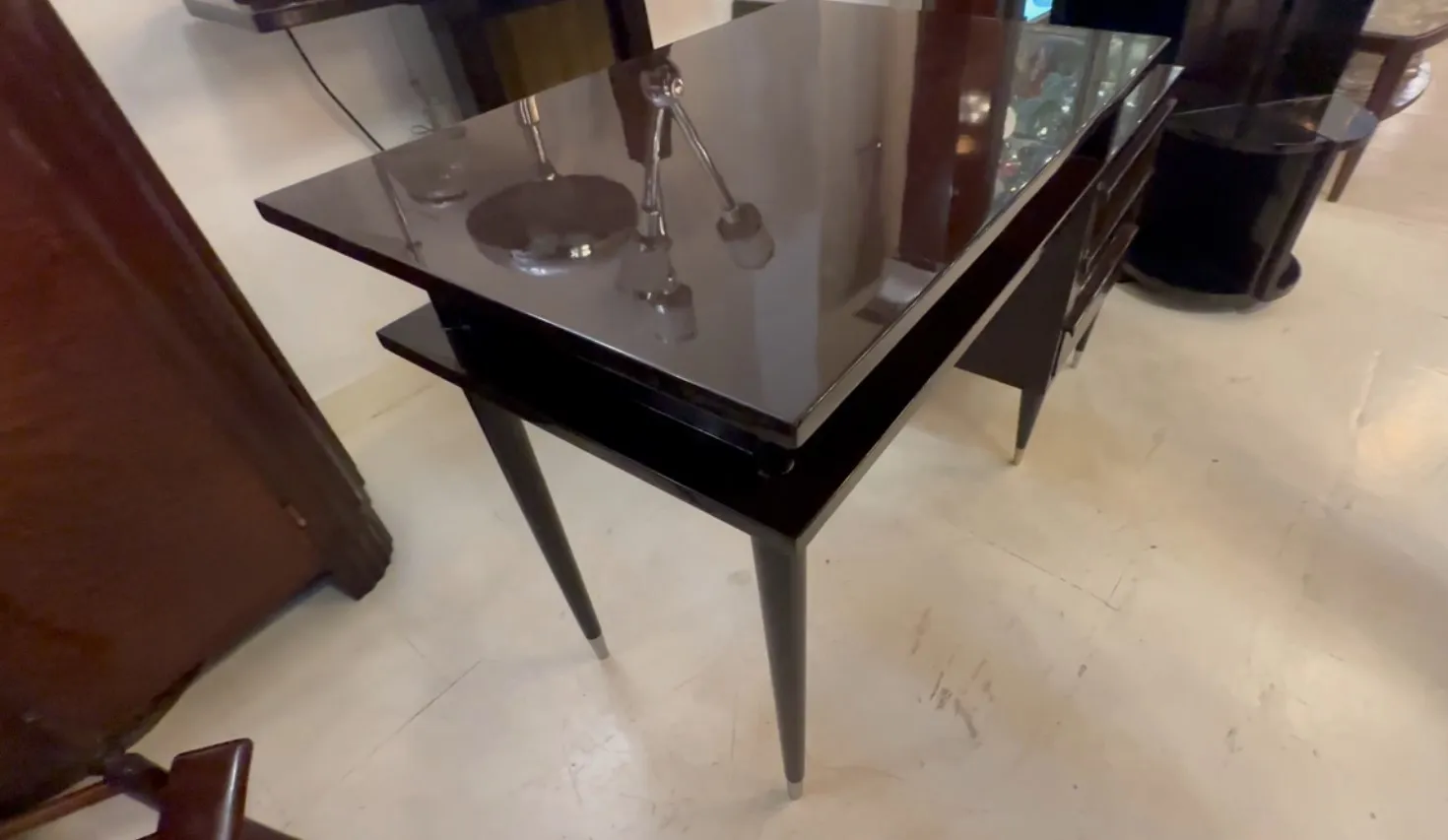 Antique shiny desk with elegant legs in a cozy setting.