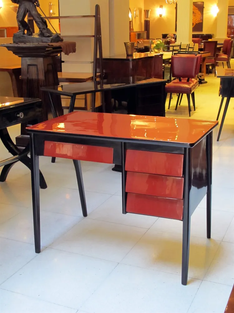 antique desk with striking red drawers in a stylish setting