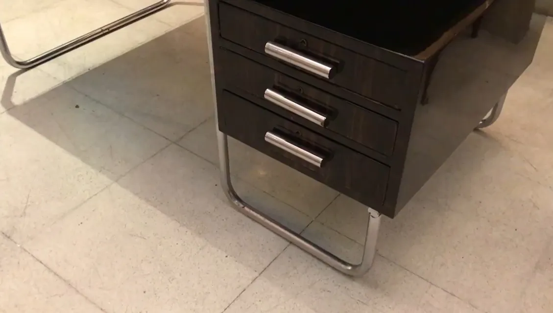 close-up view of an antique marcel breuer desk with three drawers